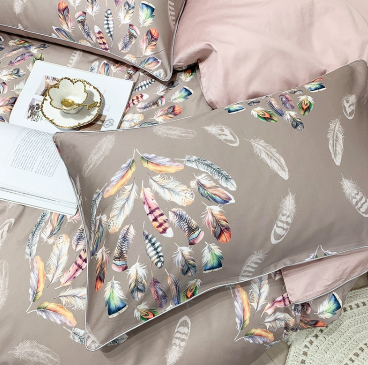 Close-up of watercolor feather pattern on taupe Egyptian cotton duvet cover and pillowcases