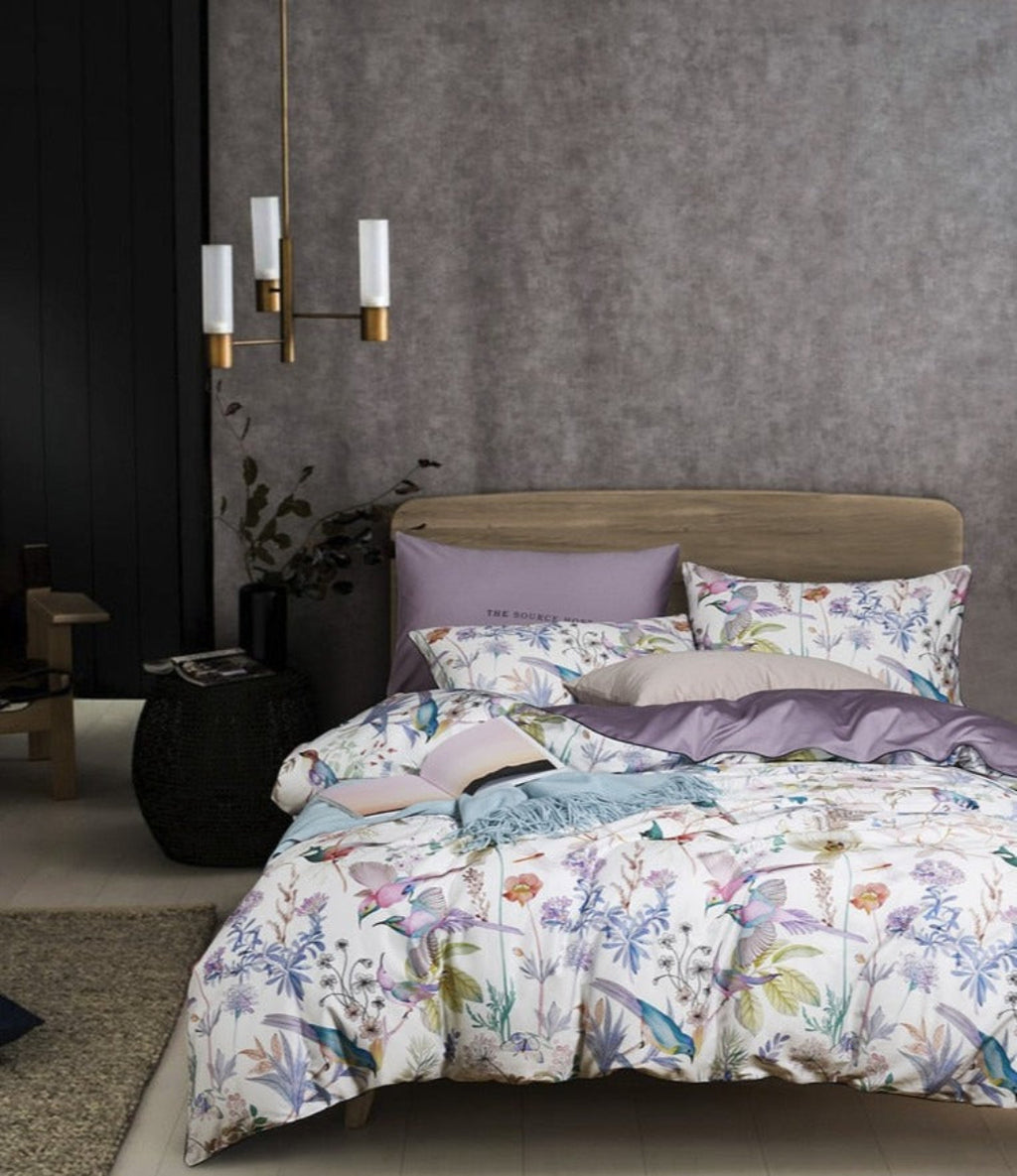 Full bedding setup of LINKORI Serenity 4-piece set with watercolor birds, florals, and lavender highlights