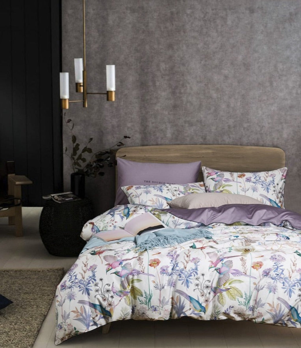 Full bedding setup of LINKORI Serenity 4-piece set with watercolor birds, florals, and lavender highlights