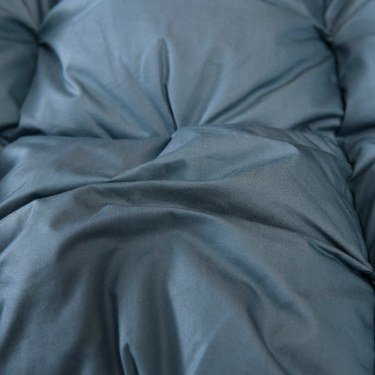 Macro texture view of 600+ thread count cotton shell on LINKORI Blue Luxurious comforter, showing breathable, smooth weave.