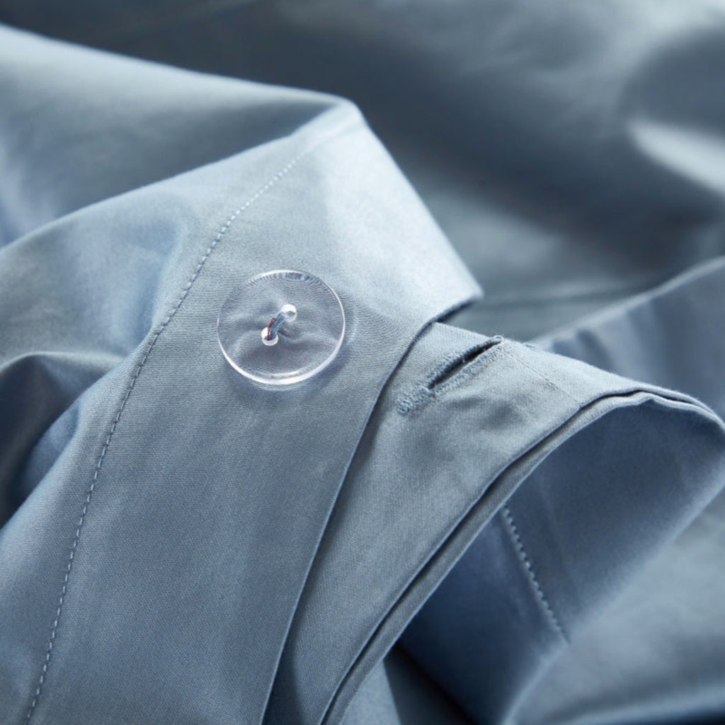 Button closure detail on LINKORI Gradiol duvet cover – minimal and secure finish in striped blue