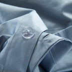 Button closure detail on LINKORI Gradiol duvet cover – minimal and secure finish in striped blue