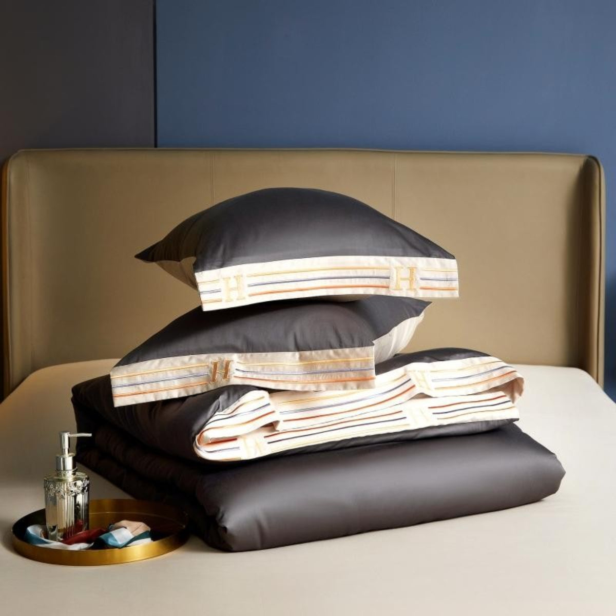 folded grey satin-finish duvet cover and two pillows on cream-gold Egyptian cotton flat sheet coordinated luxury bedding styling | LINKORI Grey Satin