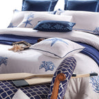 Close-up of full LINKORI Blue Coral bedding set including square pillows, flat sheet, and embroidered details