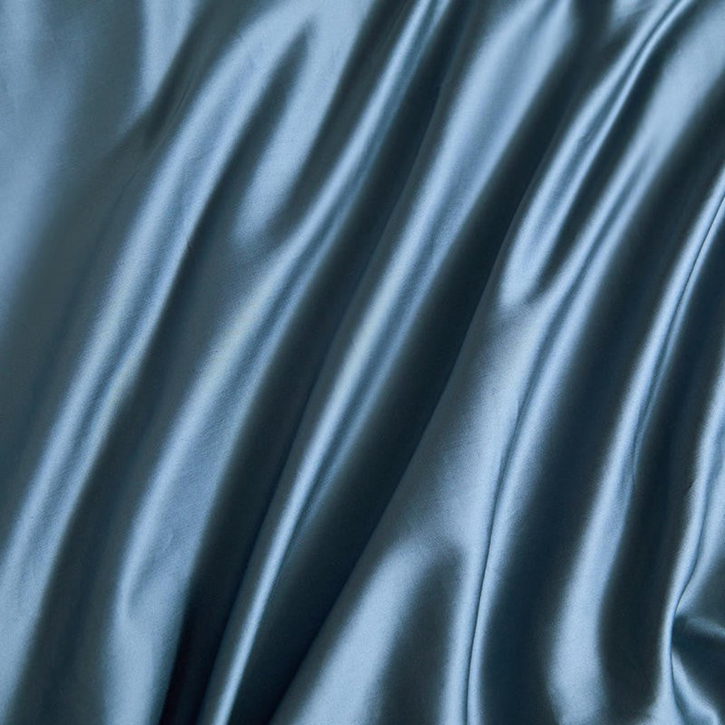Textured detail of deep blue satin duvet cover – soft sheen finish in Egyptian cotton