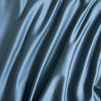 Textured detail of deep blue satin duvet cover – soft sheen finish in Egyptian cotton