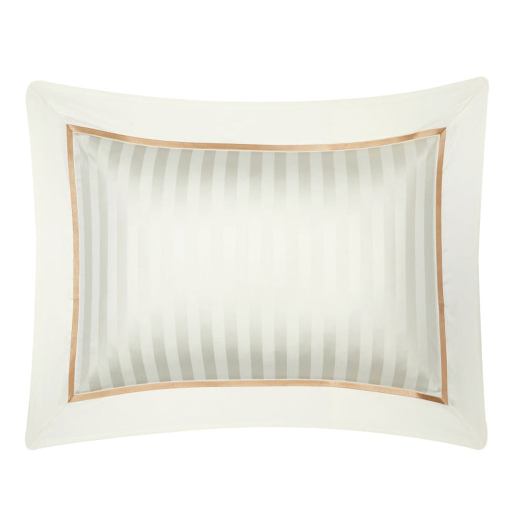 Zoomed-in view of matching beige pillowcases with subtle stripes and gold border, highlighting the clean lines and refined construction.