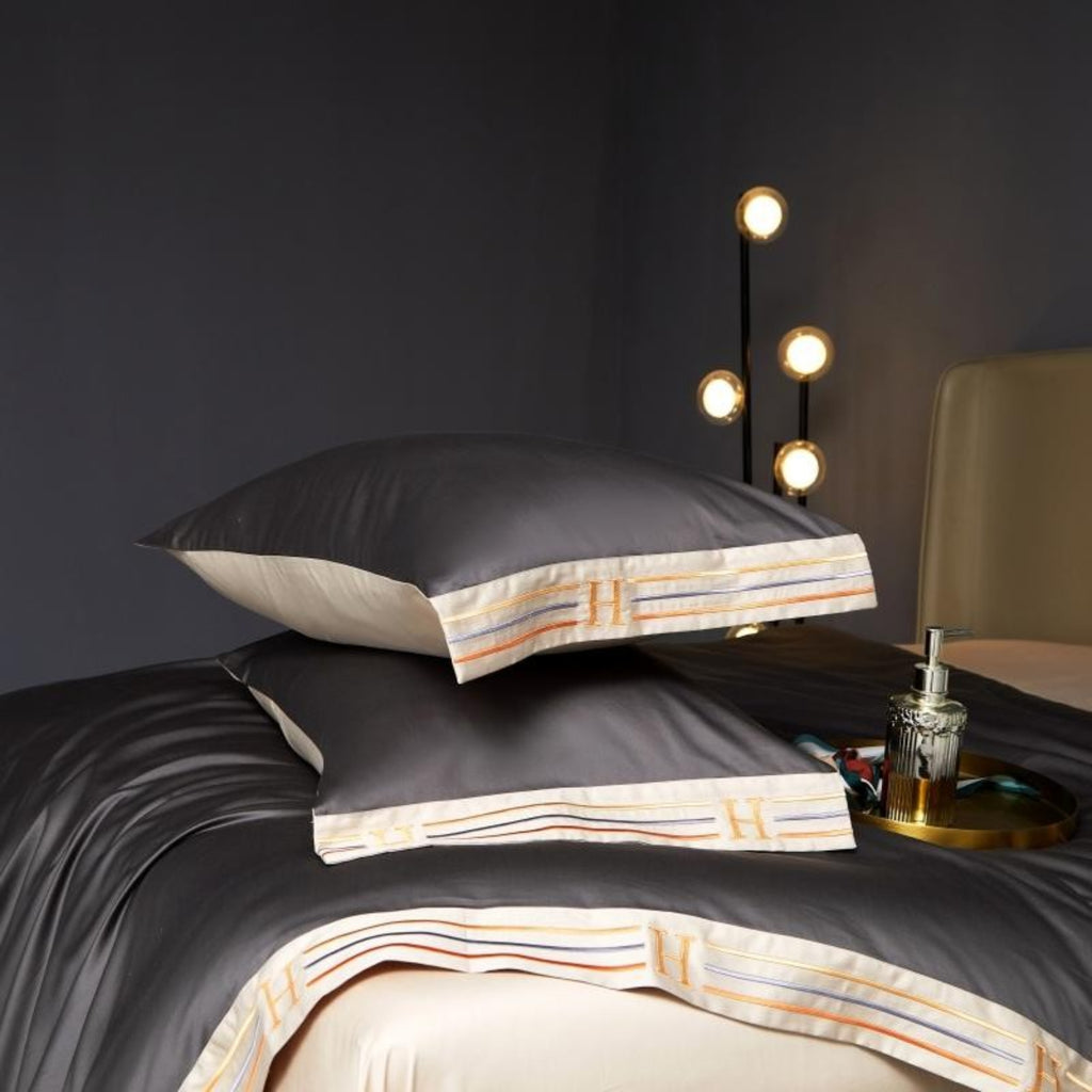 grey satin-finish duvet cover and two pillows on cream-gold flat sheet luxury Egyptian cotton bedding with modern lighting | LINKORI Grey Satin
