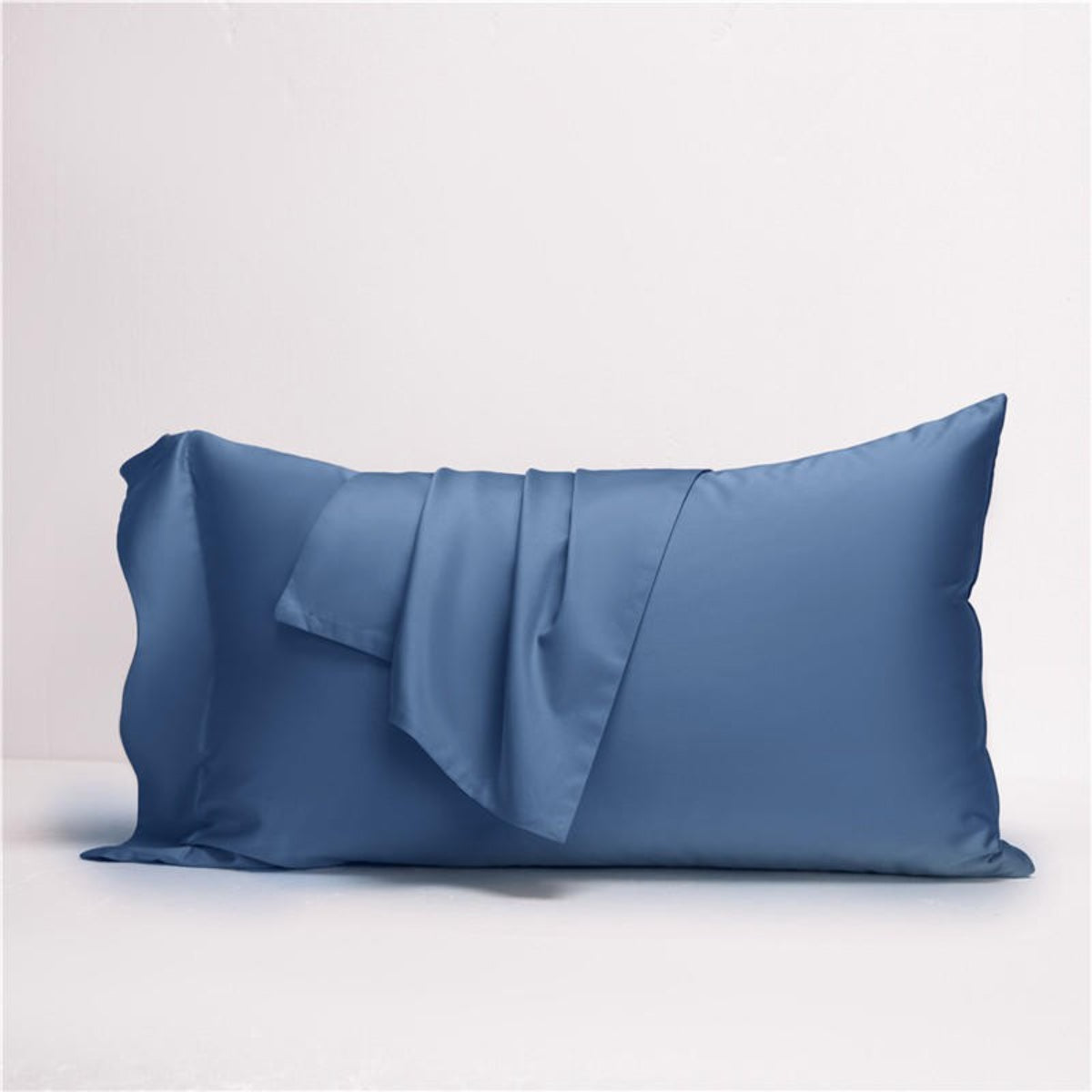 Luxury blue pillow close-up — part of blue grey reversible Egyptian cotton bedding set.