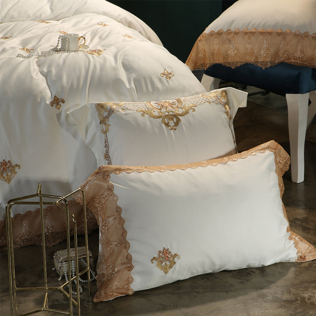 Angled close-up of LINKORI Stonge Royal pillow pair and duvet showing layered embroidery and regal finish