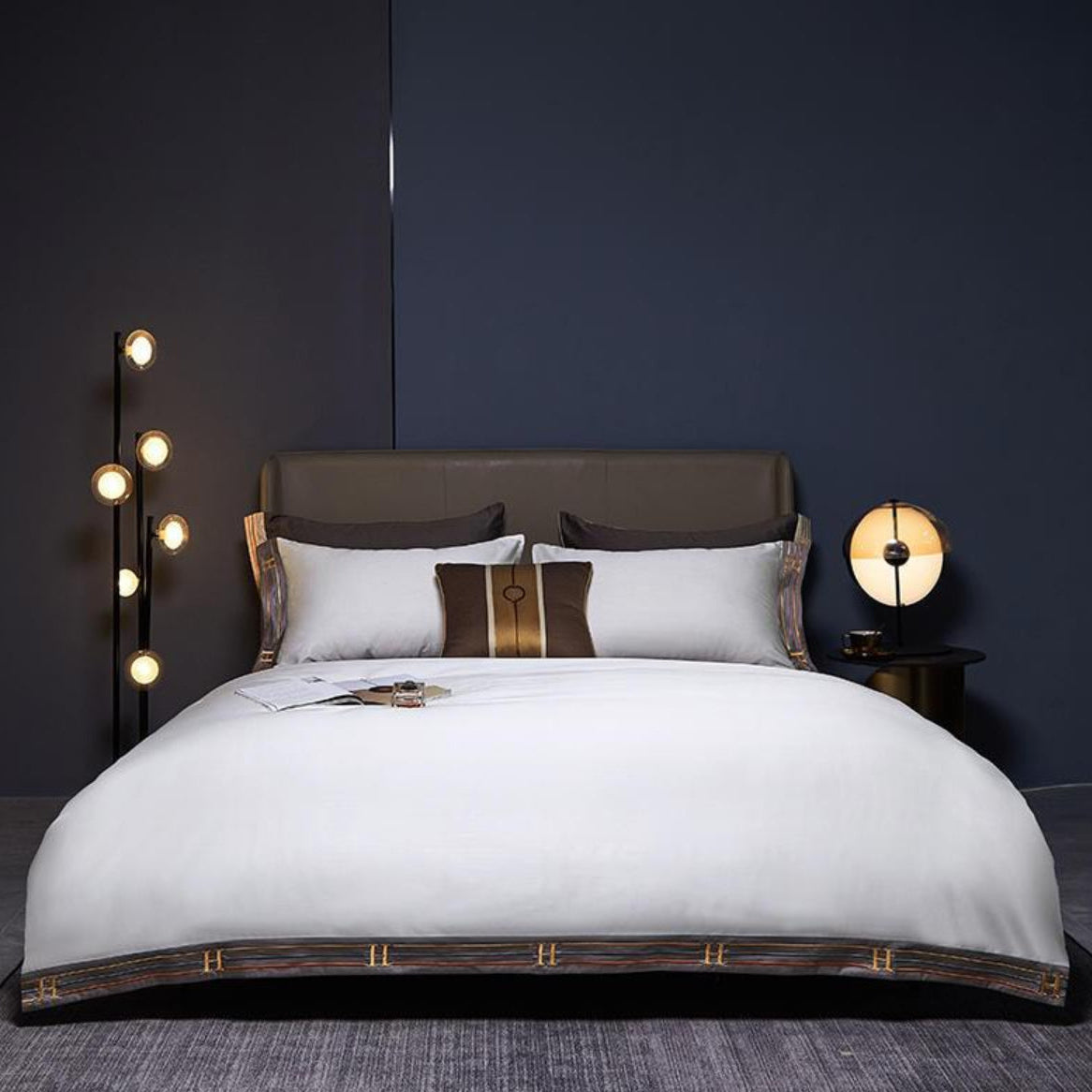 LINKORI White Satin 4-piece bedding set styled in a modern navy bedroom, featuring silky white Egyptian cotton duvet cover and pillowcases.