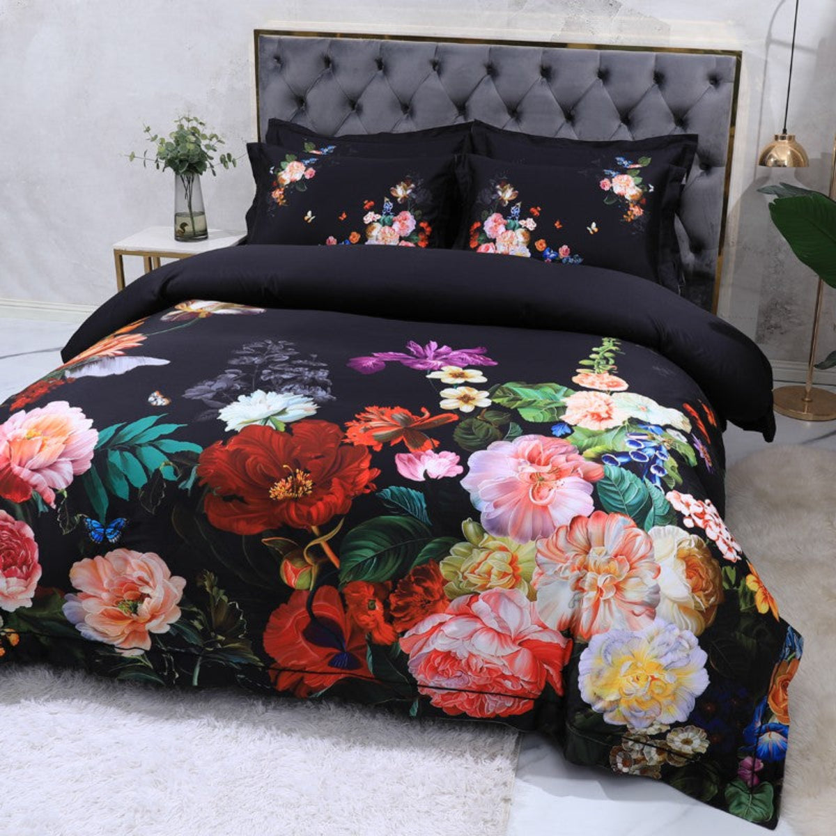 Angled overhead view of The Flowers 4-piece duvet cover set showcasing bold florals on a black Egyptian cotton base.