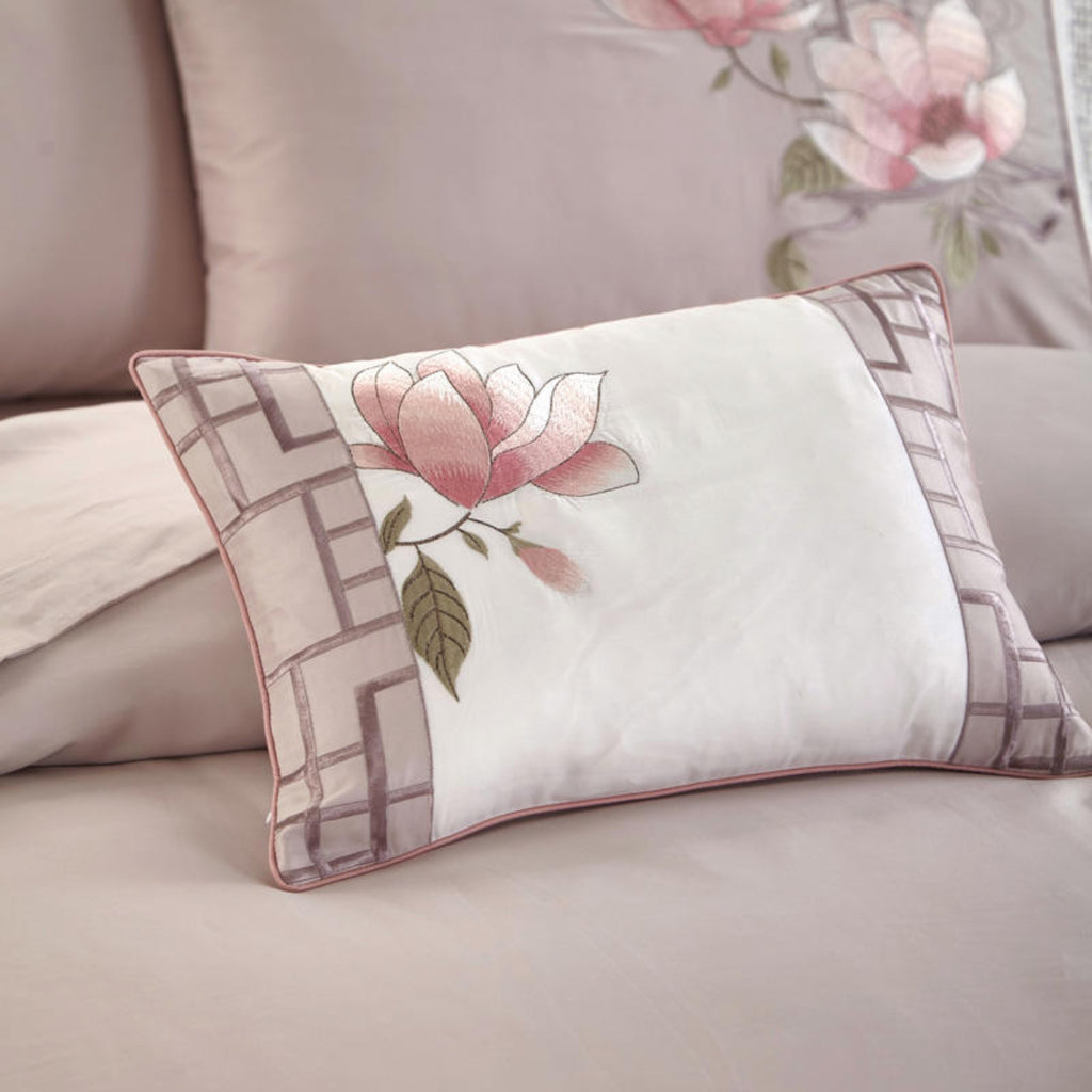 Zoomed-in view of the small decorative core pillow with matching pink floral print from the 7-piece Floraline set.
