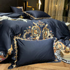 Embroidered pillow resting on black duvet cover, showcasing baroque floral details and precise stitching.