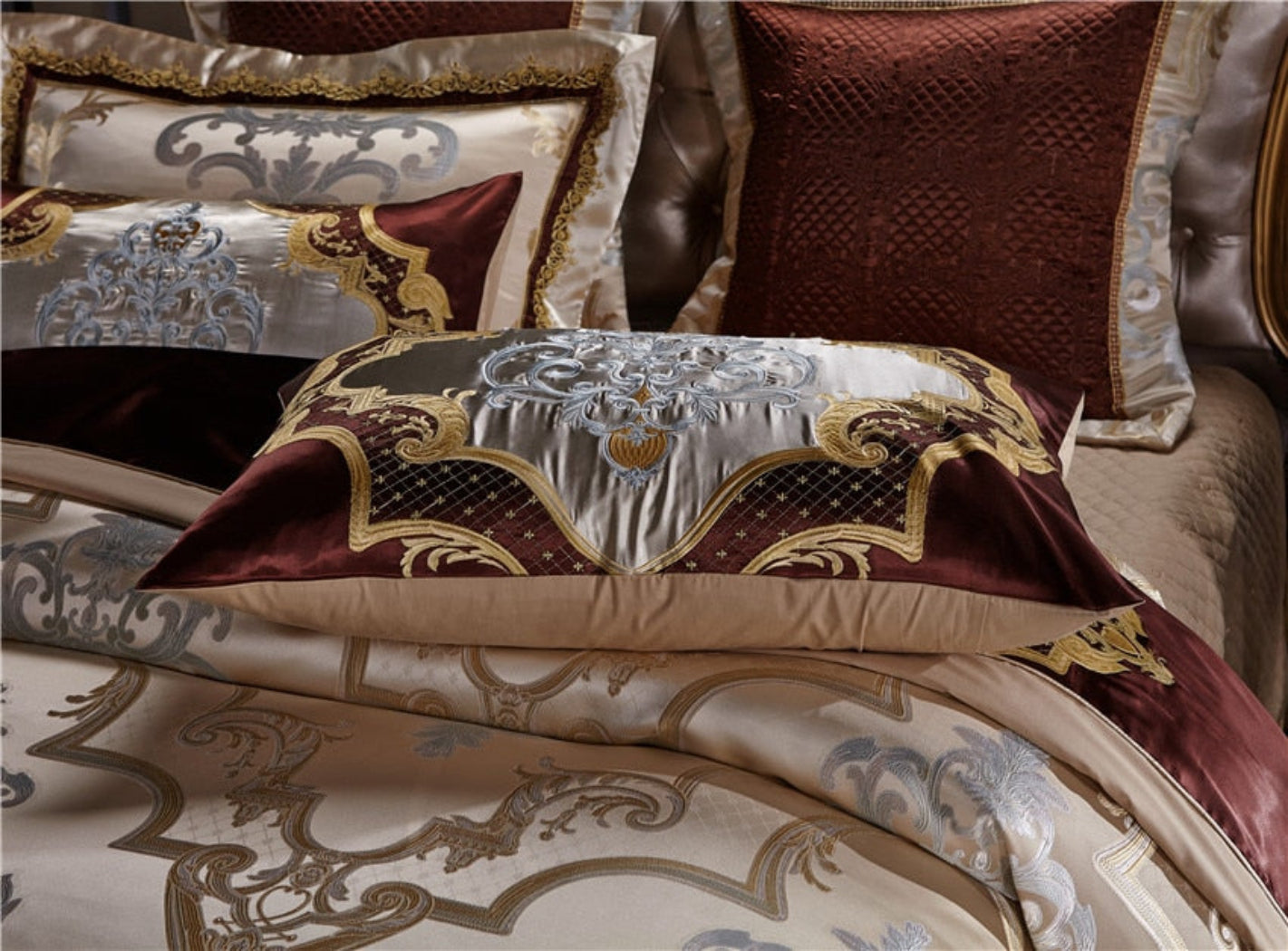 Three embroidered pillow designs styled on LINKORI Specto duvet – royal detailing with silk texture