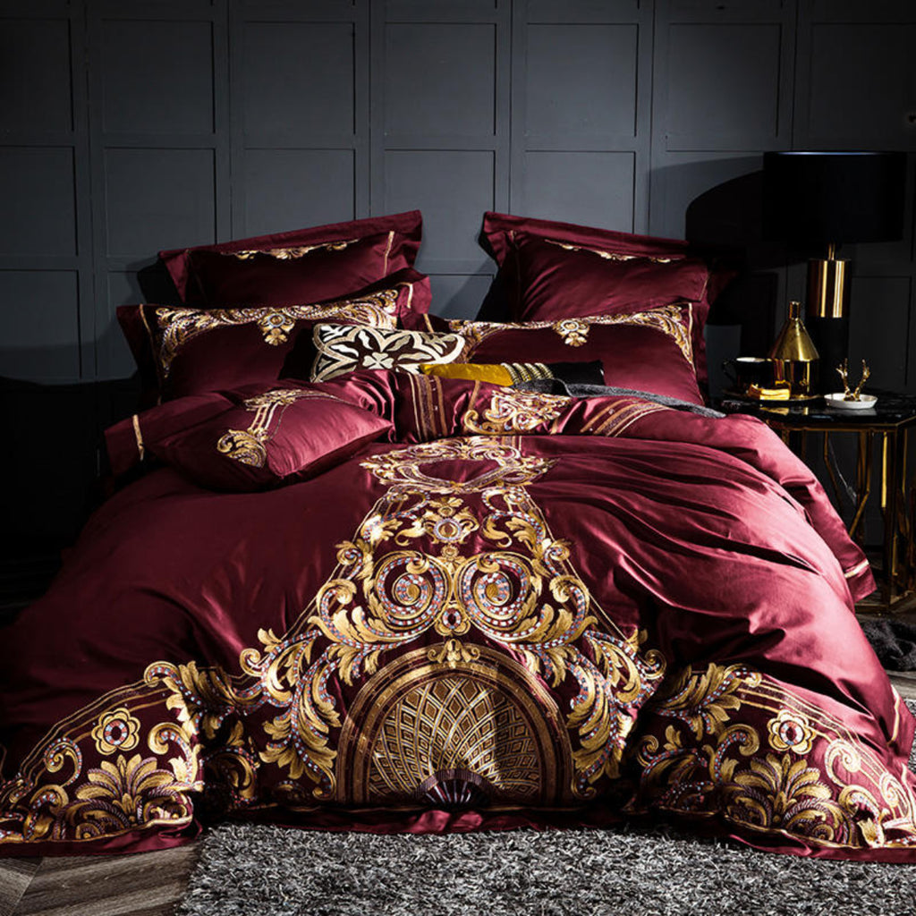 Full view of LINKORI Zutapera bedding set – royal red duvet cover with bold gold baroque embroidery and pillow arrangement