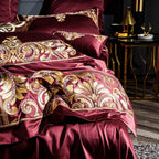 Close-up of duvet and pillows from LINKORI Zutapera – golden baroque embroidery on deep red Egyptian cotton