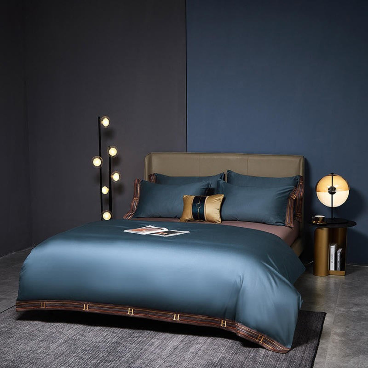 Modern interior with deep blue satin bedding set – brown trim and coordinated flat sheet
