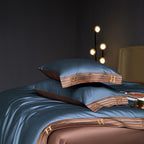 Blue satin bedding with brown embroidered trim and matching brown flat sheet