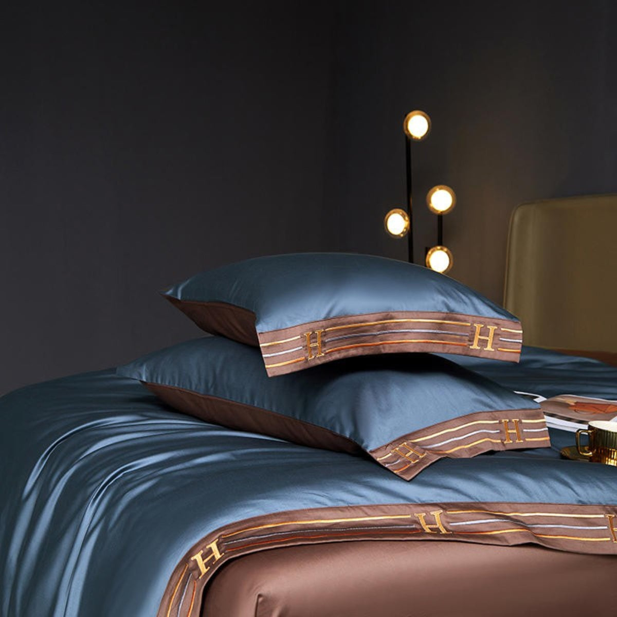 Blue satin bedding with brown embroidered trim and matching brown flat sheet