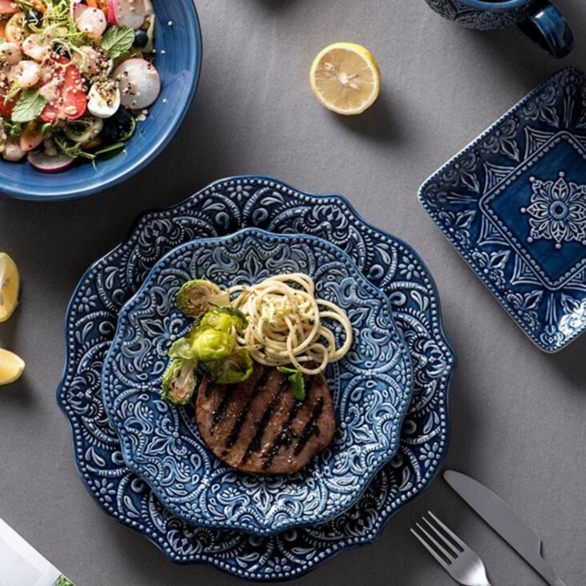 Dinner plate from LINKORI Gratique set with food plated – showcasing deep blue ceramic design with intricate detailing