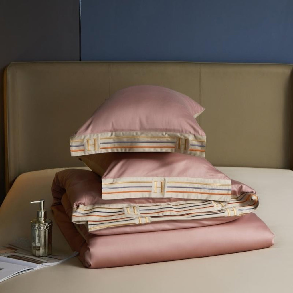 Folded pink duvet cover and pillows on beige sheet – elegant and minimal bedding layering | LINKORI, folded set view