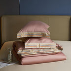 Folded pink duvet cover and pillows on beige sheet – elegant and minimal bedding layering | LINKORI, folded set view