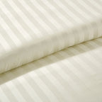 Macro view of the soft stripe pattern on the duvet cover, illustrating its subtle design and gentle sheen.