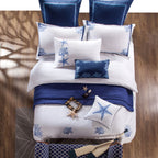 Top-down flat lay of Blue Coral bedding set showcasing ocean motifs and 100% Egyptian cotton texture