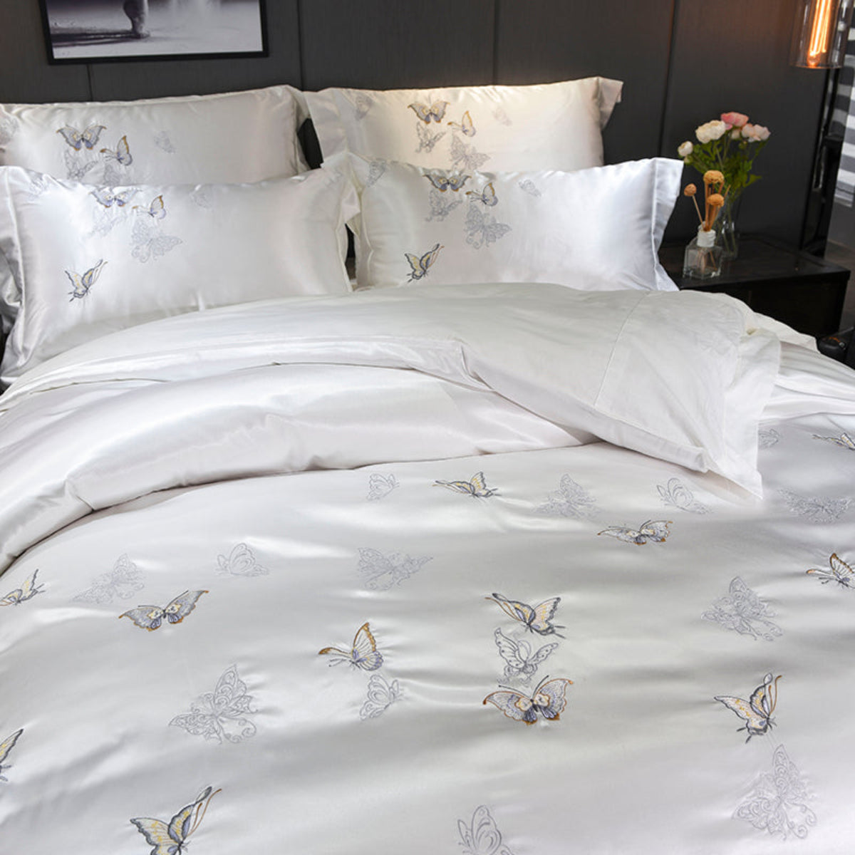 Semi-close-up view of the complete 4-piece LINKORI Silvely Butterfly bedding set, highlighting embroidery and satin sheen.


