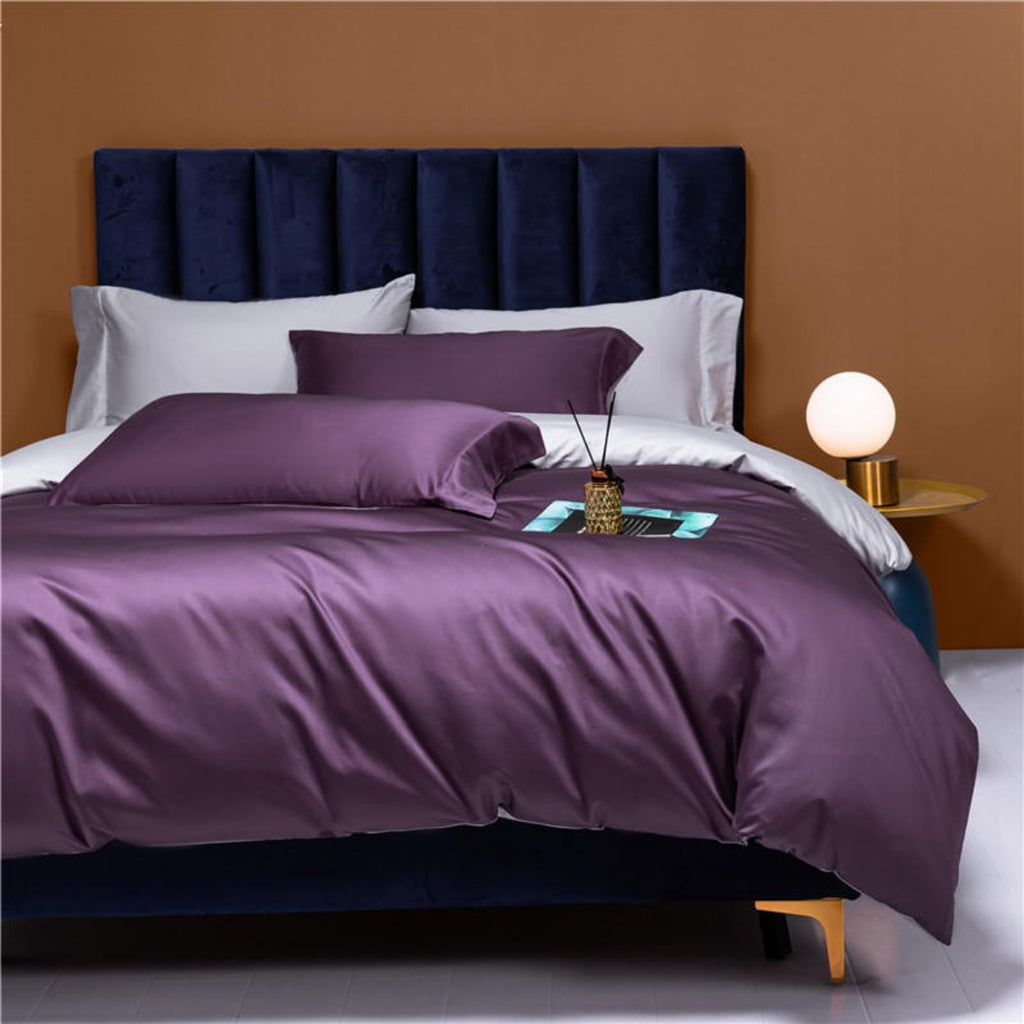 Elegant angle of LINKORI Neslla Purple reversible bedding set showing bold color contrast and fluid drape on queen-size bed