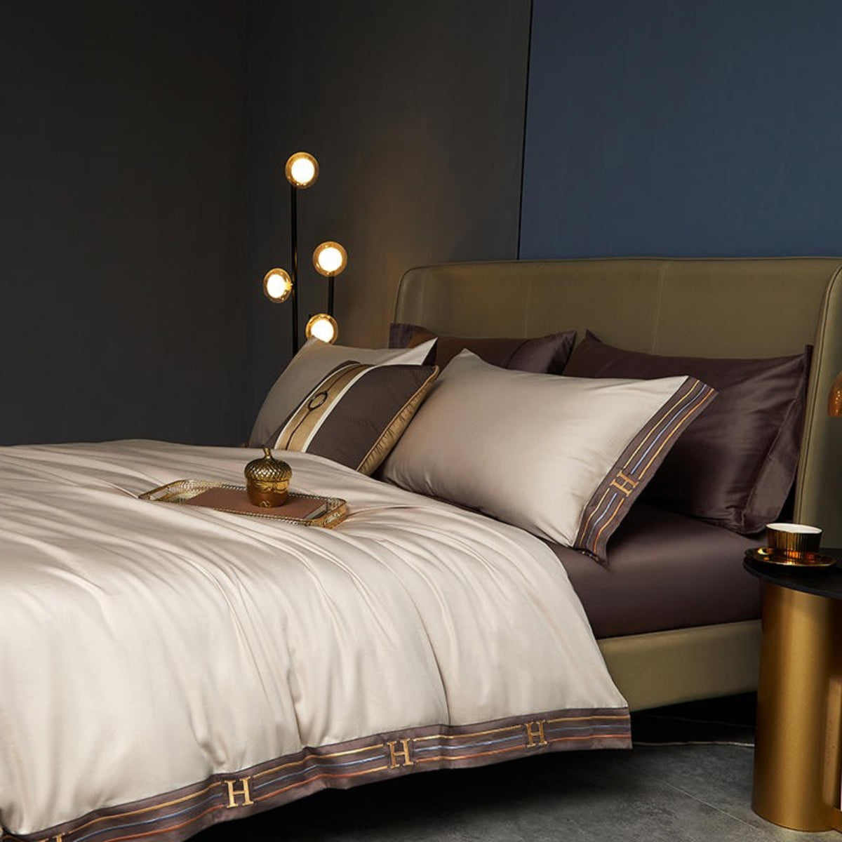 Beige silky duvet cover with brown cotton flat sheet and matching pillowcases with decorative trim