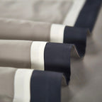 Close-up of champagne-toned duvet cover edge with deep navy lining — showcasing precise border design and modern tailoring.