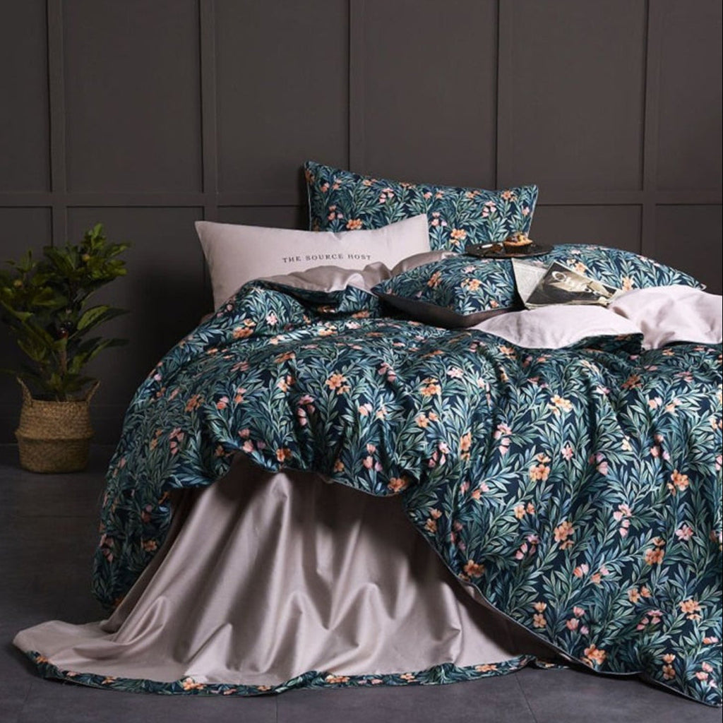 Full view of botanical duvet cover set in teal green with coral floral patterns and beige-grey flat sheet | LINKORI On the Grass
