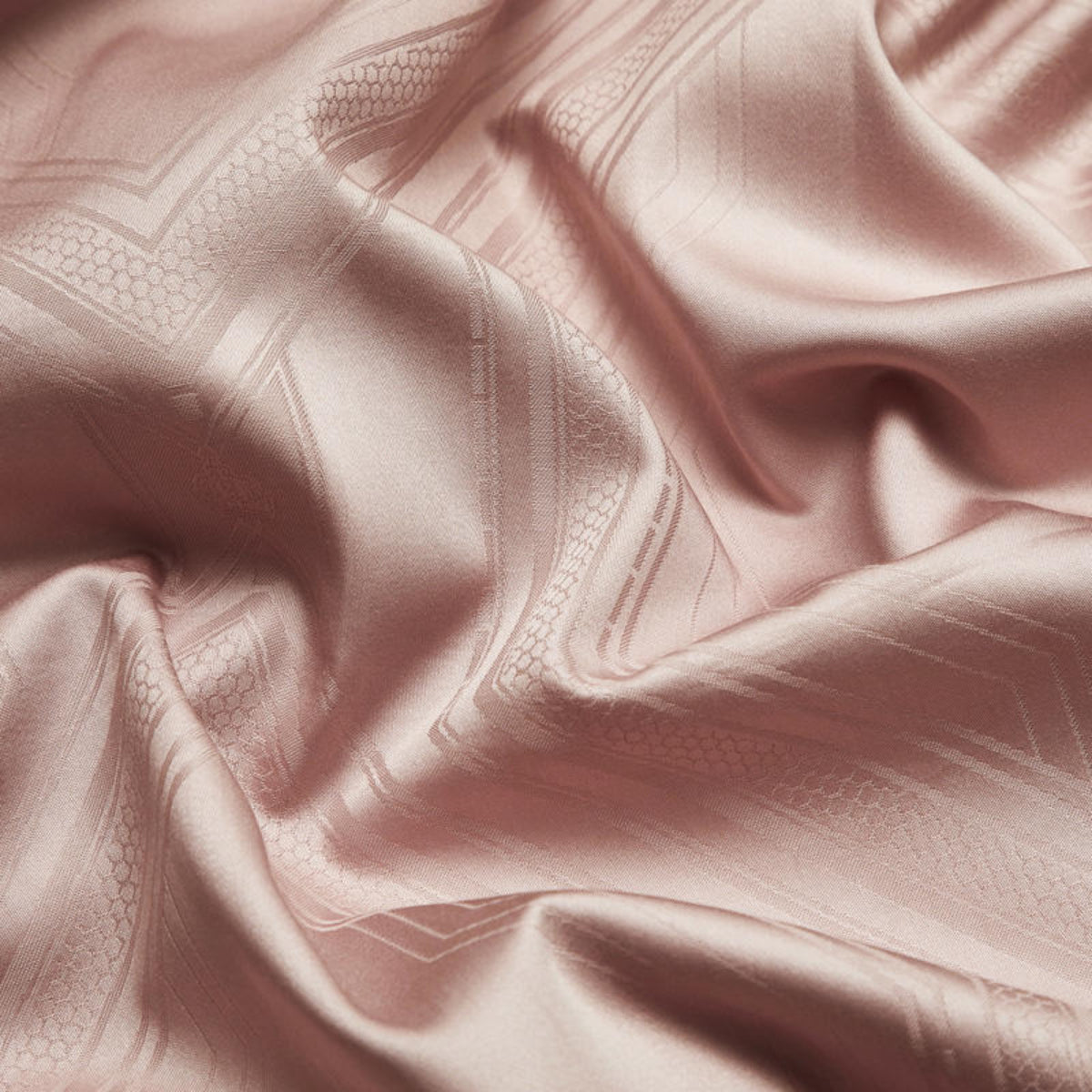Close-up of dusty pink satin duvet cover texture – geometric jacquard weave with silky-soft surface and subtle sheen | LINKORI, fabric close-up