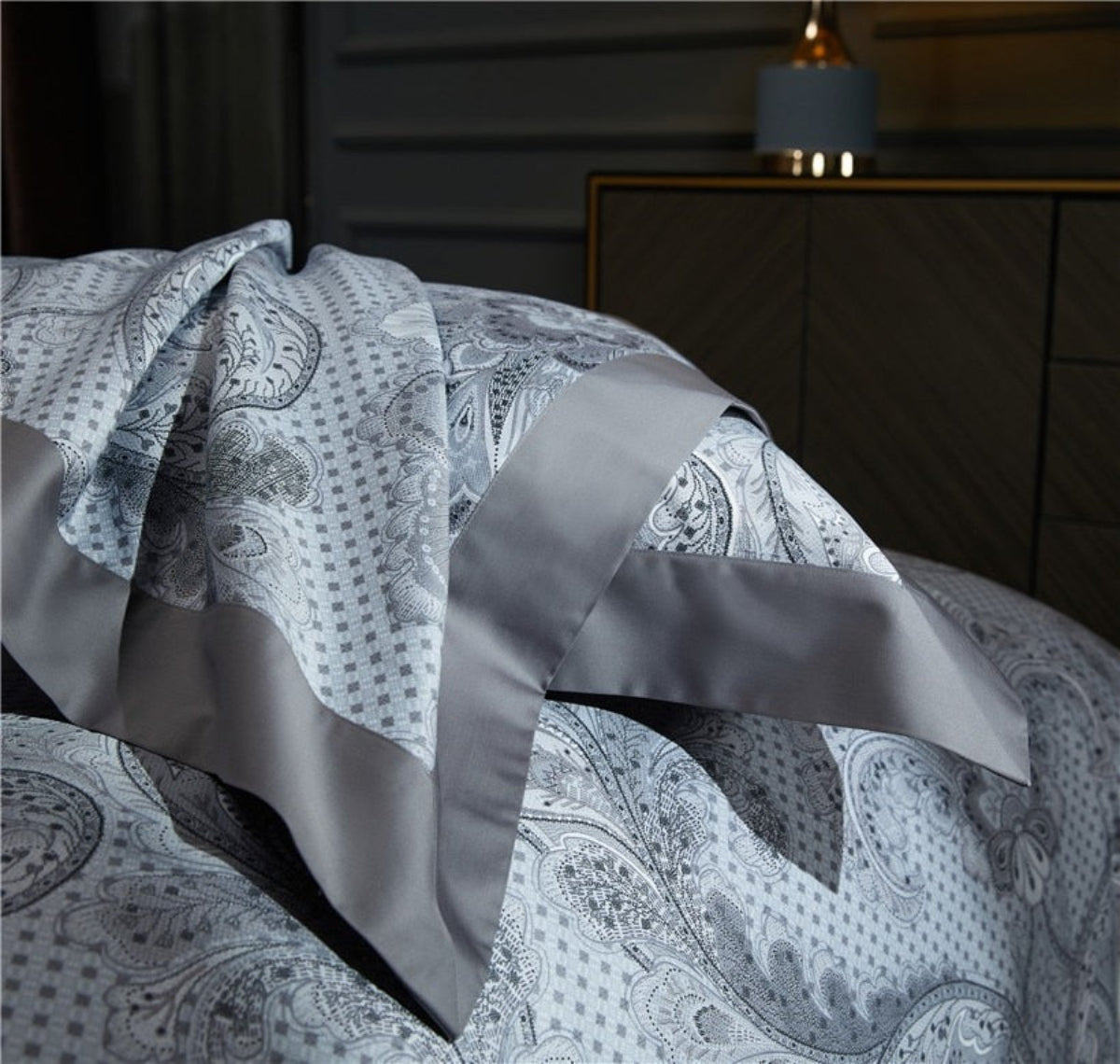 Grey floral pillow with smoky piping on soft flat sheet – elegant contrast and sculptural design for luxury bedding | LINKORI, detail view