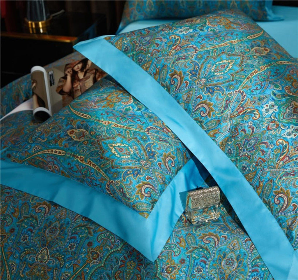 Close-up of turquoise flat sheet with matching border pillow shams — High-end hotel finish with unified color scheme for luxury bedrooms.