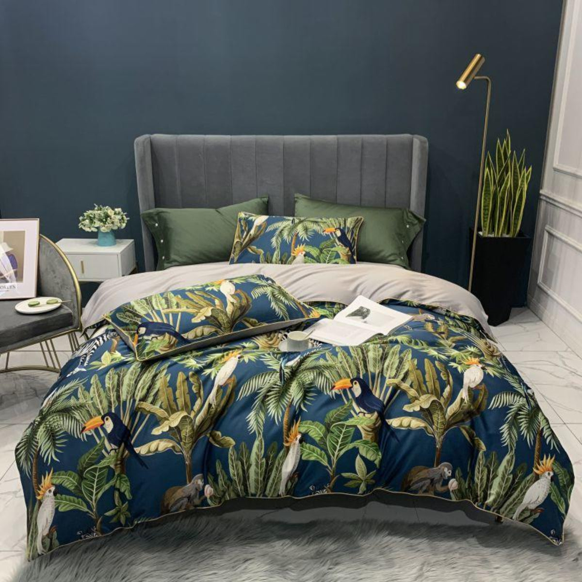 Full view of LINKORI Junglia duvet cover set in tropical bird and leaf print, styled with green pillows and a grey headboard.