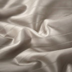 Macro shot of soft 800 thread count Egyptian cotton fabric with smooth weave texture in satin champagne finish.